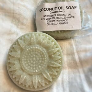 a daisy shaped light green soap made with coconut oil and aloe vera gel