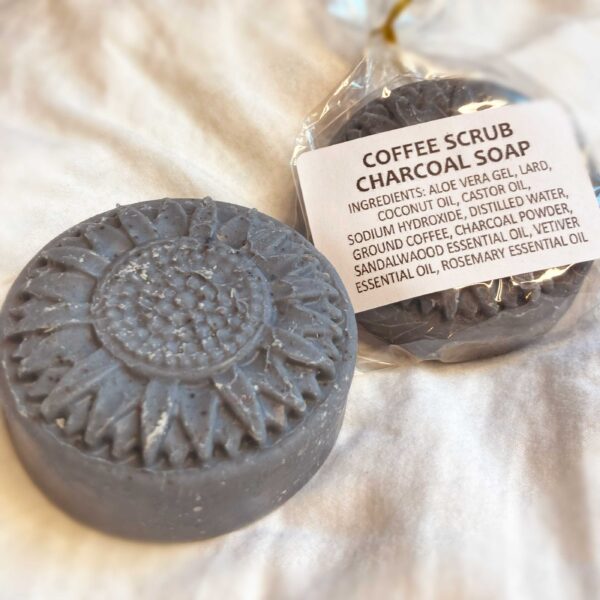 A dark gray daisy mold soap with black speckles